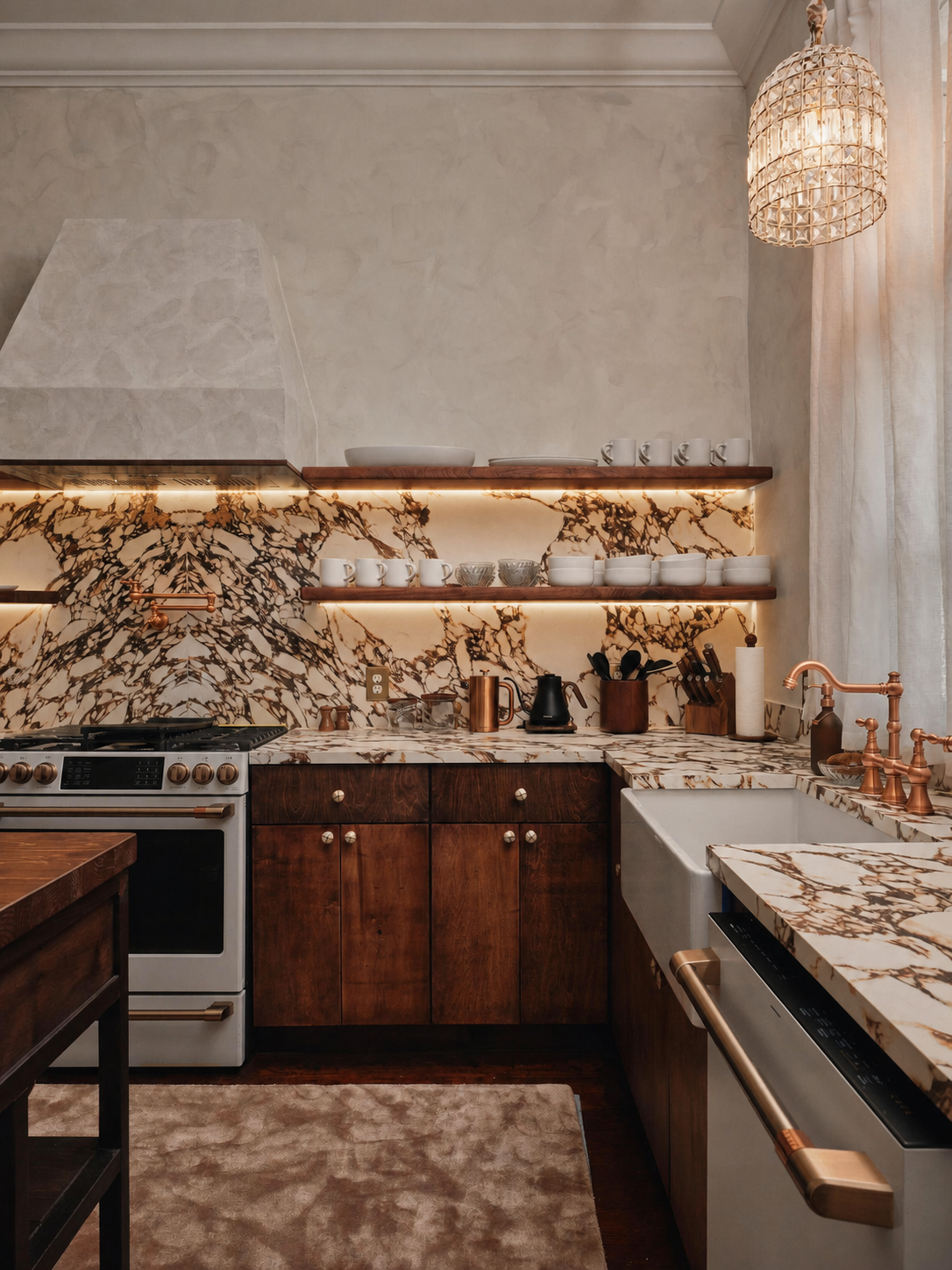 Angled view of the range and marble backsplash, pot-filler and pendant light in frame